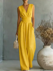 Yellow sleeveless wide-leg jumpsuit with V-neck, cinched waist, and pockets.