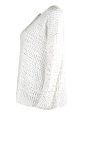 White asymmetric slouch knit sweater with open shoulder detail and textured acrylic fabric.