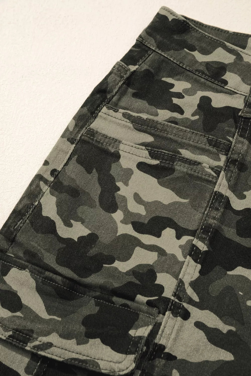 Women's camo print cotton cargo jeans with utility pockets.