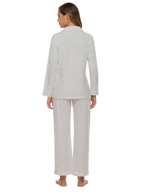 White polka dot pajama set with collar and pink trim.