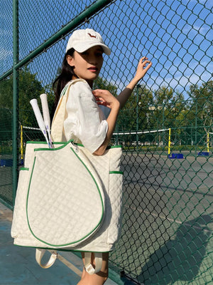 Off-white quilted sports racket backpack with green trim, tennis rackets visible.