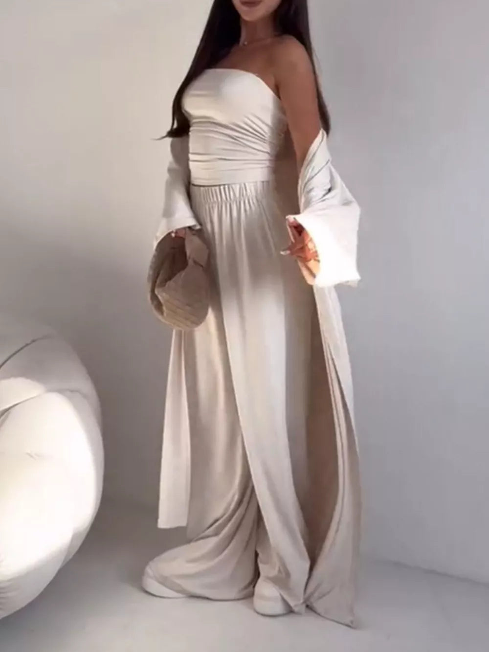 Chic three-piece maternity set in white with a ruched bandeau top, wide-leg pants, and a long cardigan.