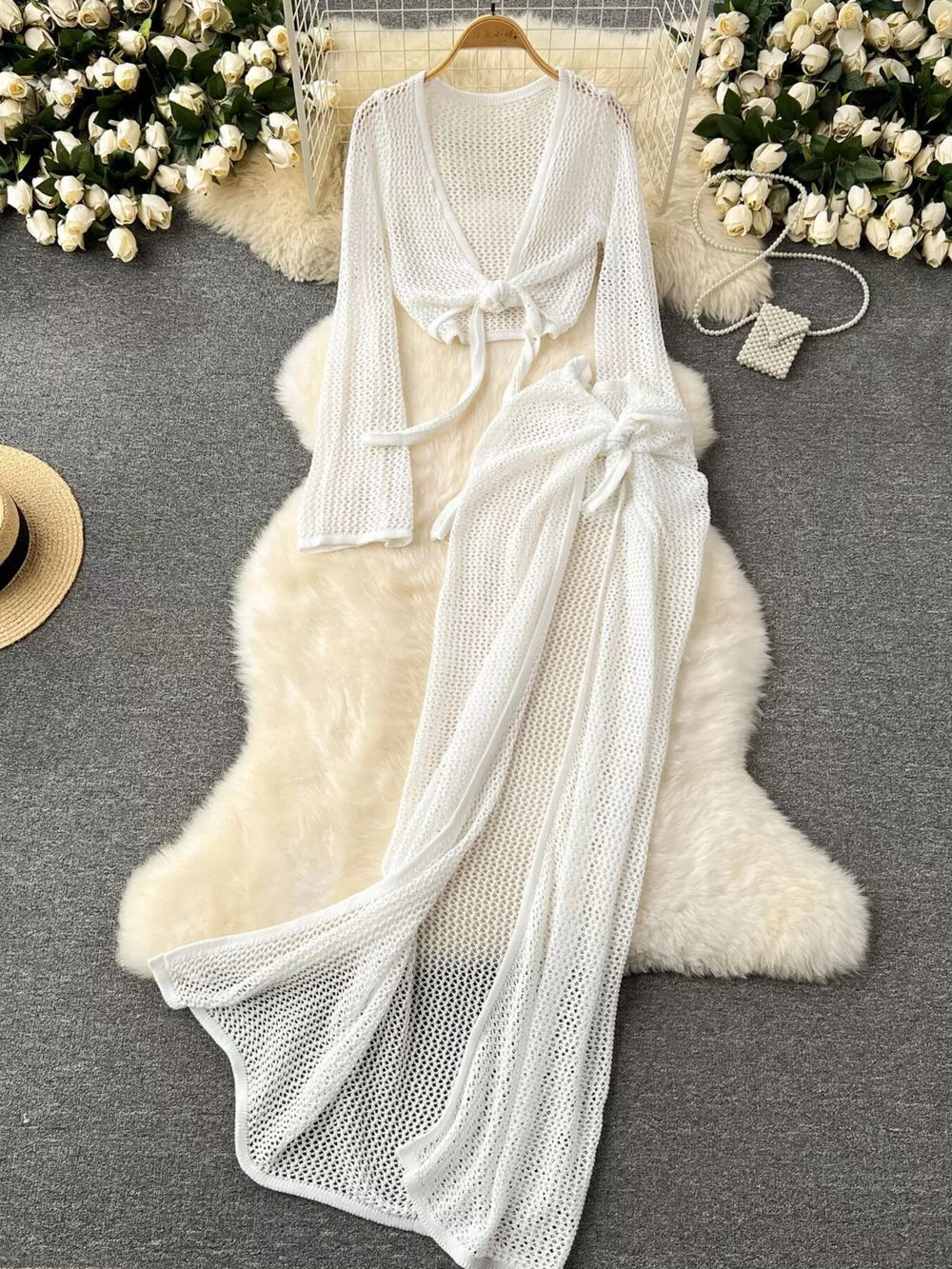 White knit tied crop top with long sleeves and matching high slit maxi skirt.