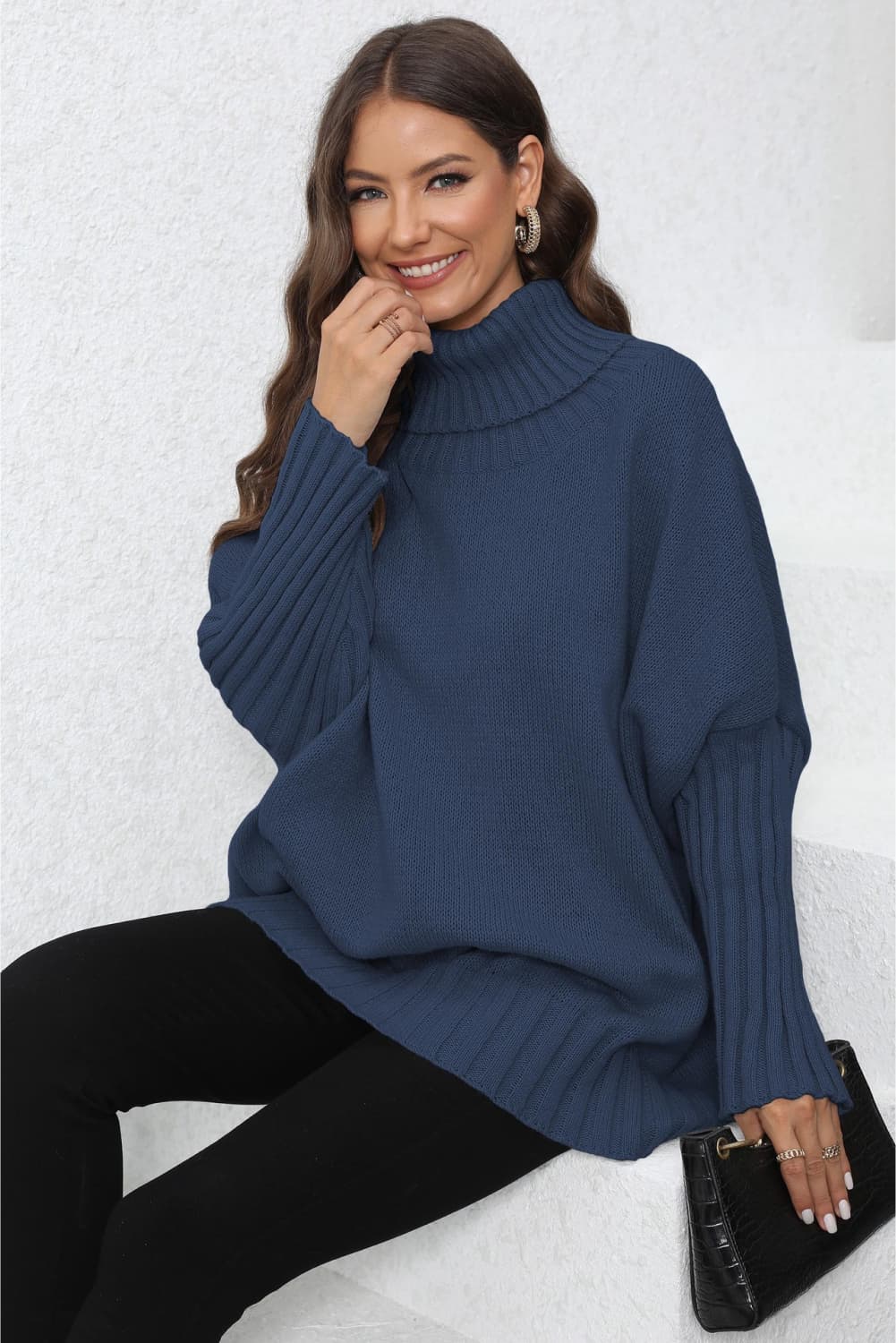 Dark blue ribbed turtleneck sweater with batwing sleeves and a relaxed fit.