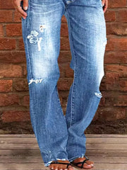 Relaxed fit distressed blue denim maternity jeans with raw hem and button fly.