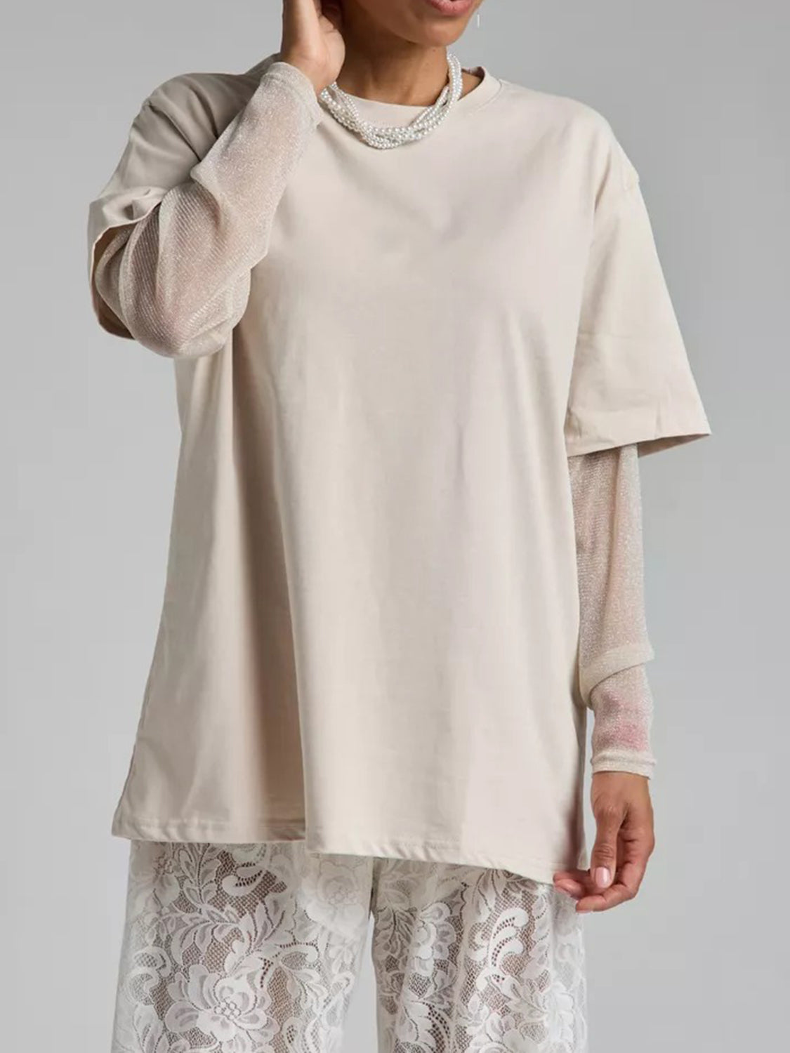 Oversized camel tee with sheer metallic long sleeves layered underneath.