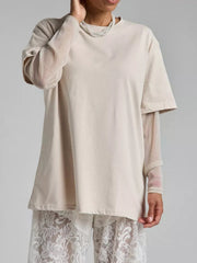 Oversized camel tee with sheer metallic long sleeves layered underneath.