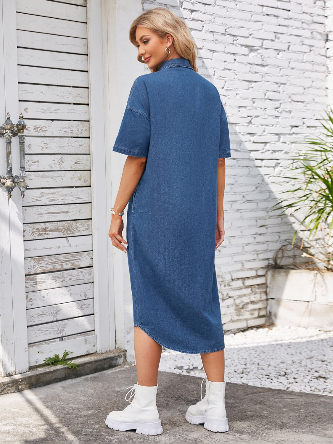 Denim shirtdress in dusty blue with short sleeves and an asymmetric hemline.