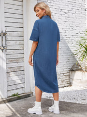 Denim shirtdress in dusty blue with short sleeves and an asymmetric hemline.
