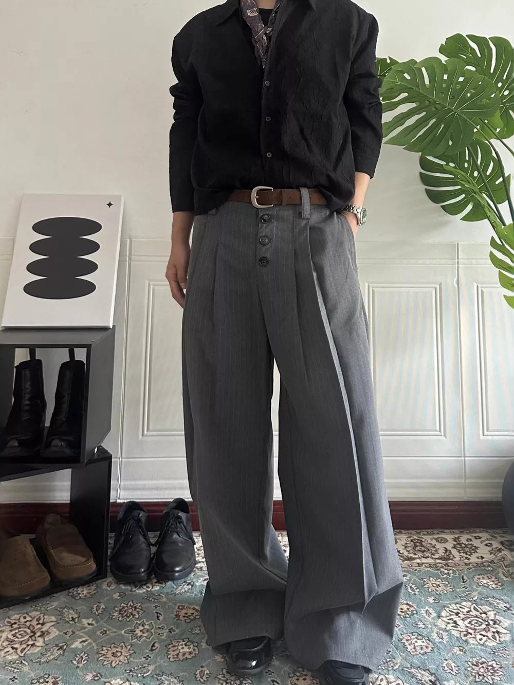 Men's gray pinstripe wide-leg pants with high waist and button fly.