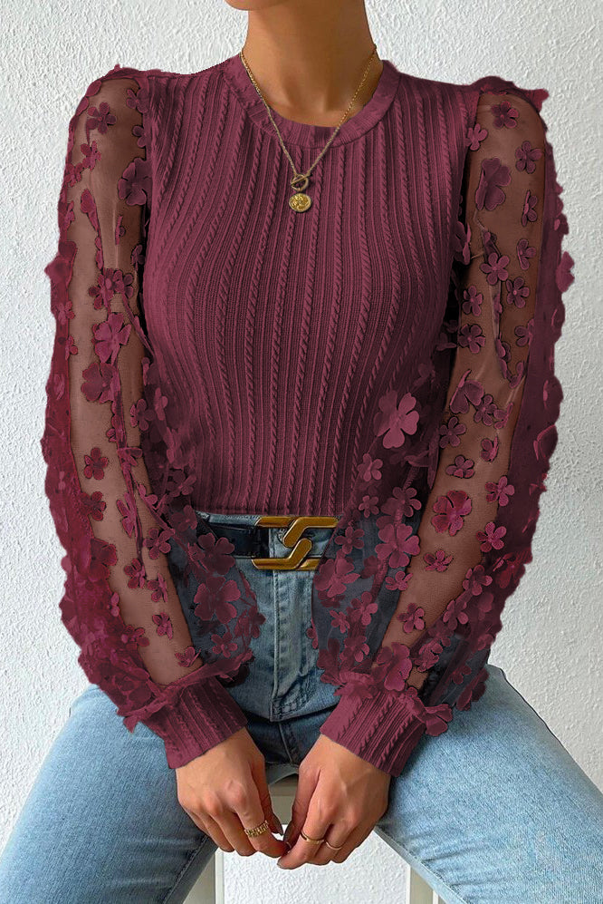 Wine knit top with sheer floral appliqué sleeves and crew neck.