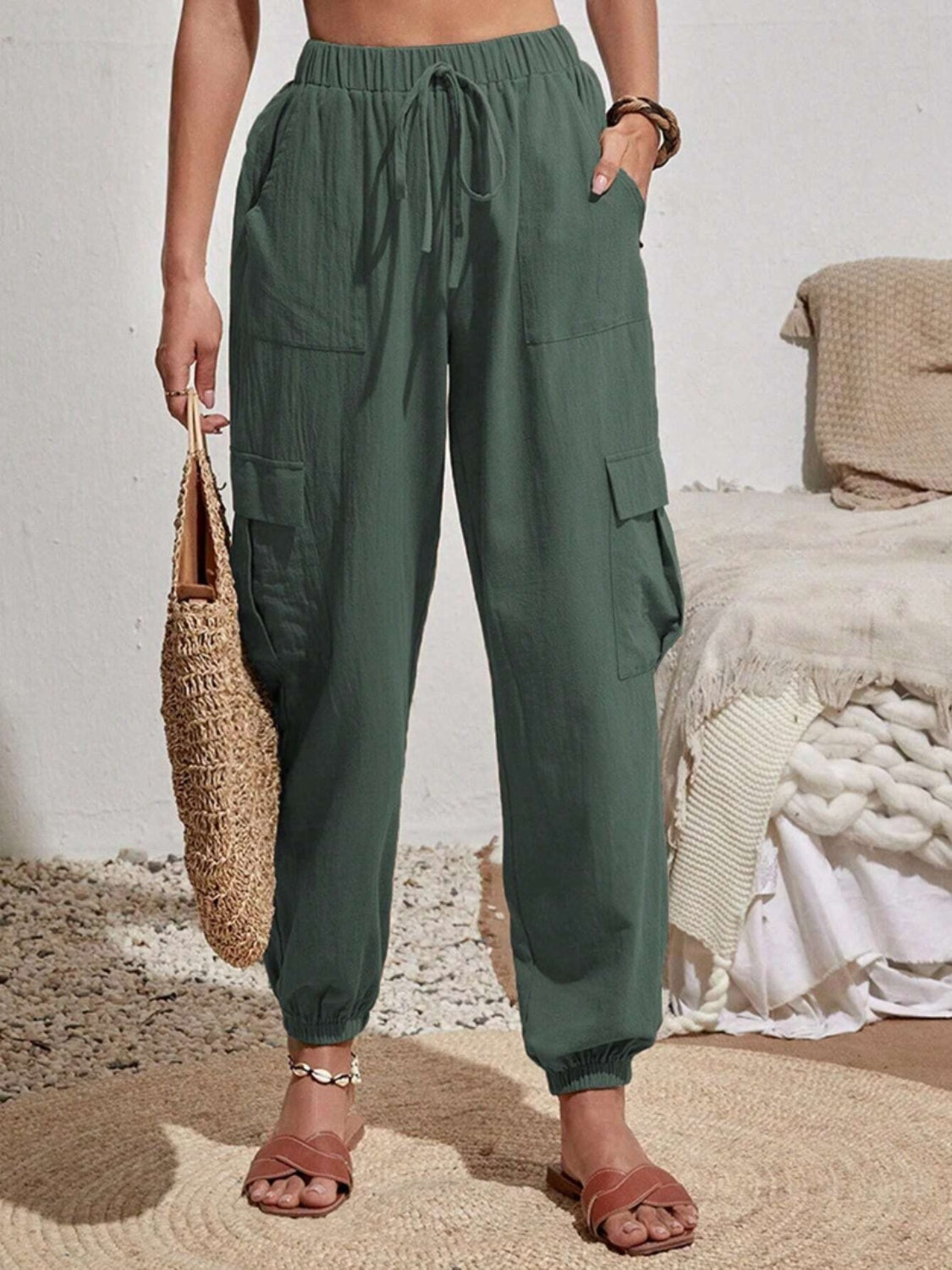 Textured cargo lounge trousers in dark green with drawstring waist and elastic cuffs.