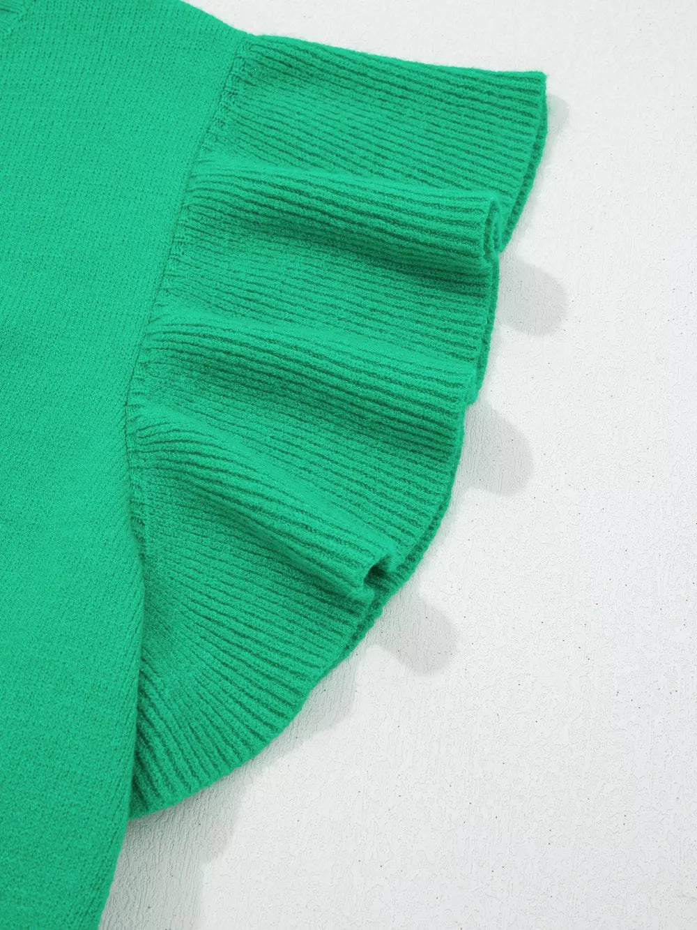 Green ribbed knit top with ruffled short sleeves and round neck.