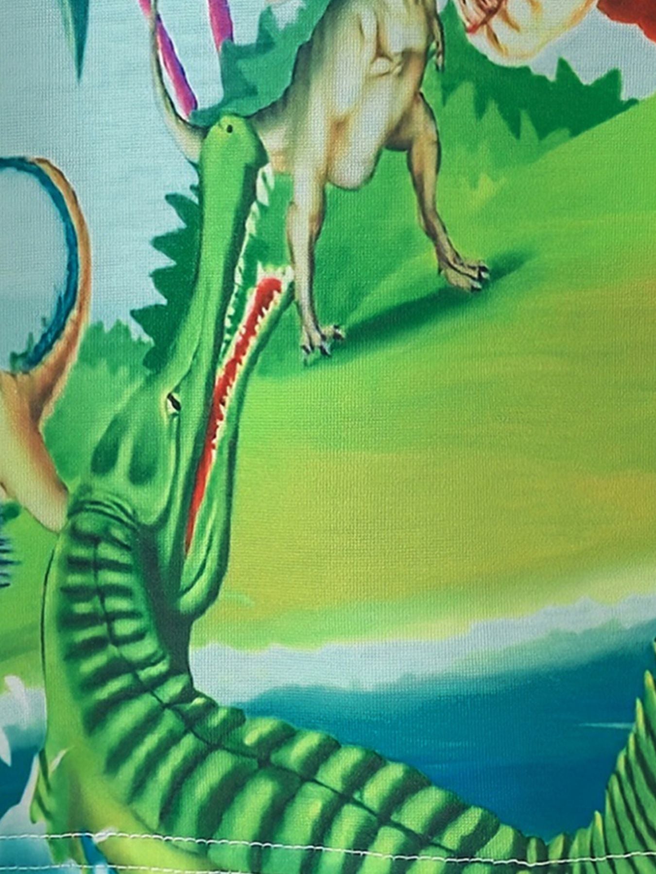 Toddler t-shirt with colorful dinosaur adventure print, green crewneck.