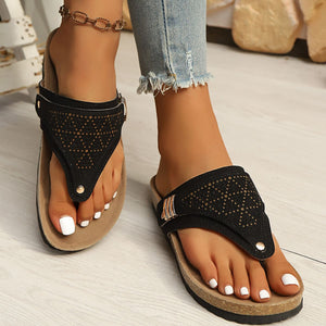 Black hollow-out toe-post sandals with adjustable ankle strap and cork-style sole.