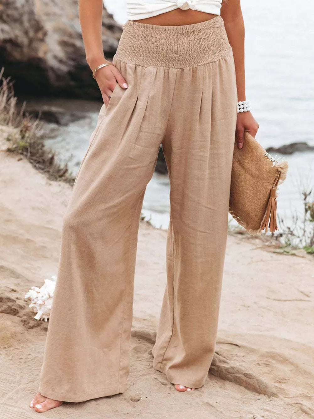Tan smocked waist wide-leg maternity pants with pleats and pockets