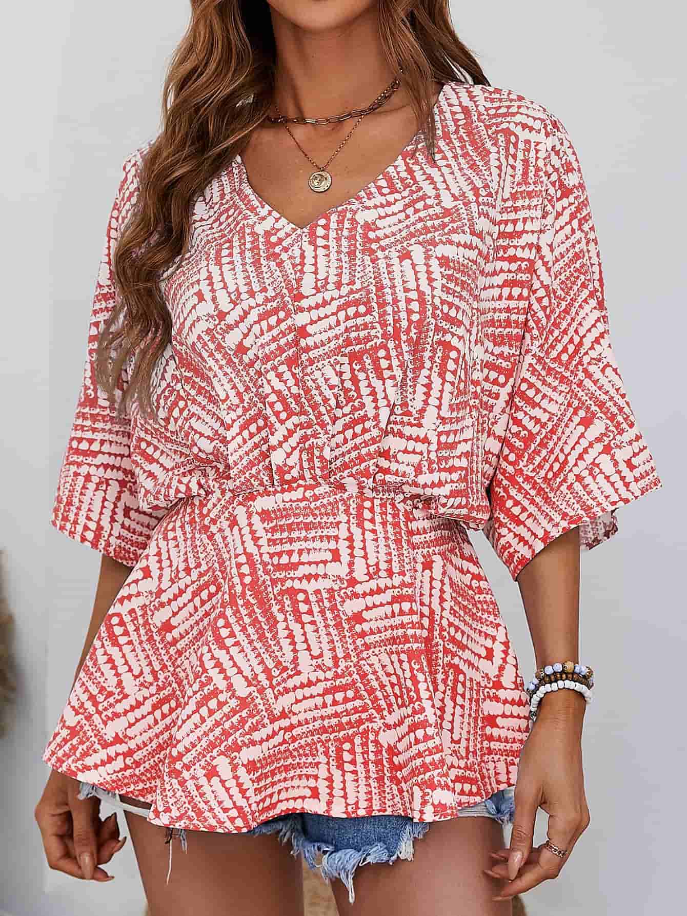 Women's scarlet abstract print cinched waist v-neck blouse with short sleeves.