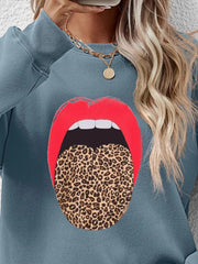 Light Blue sweatshirt with bold red lips and leopard print tongue graphic.