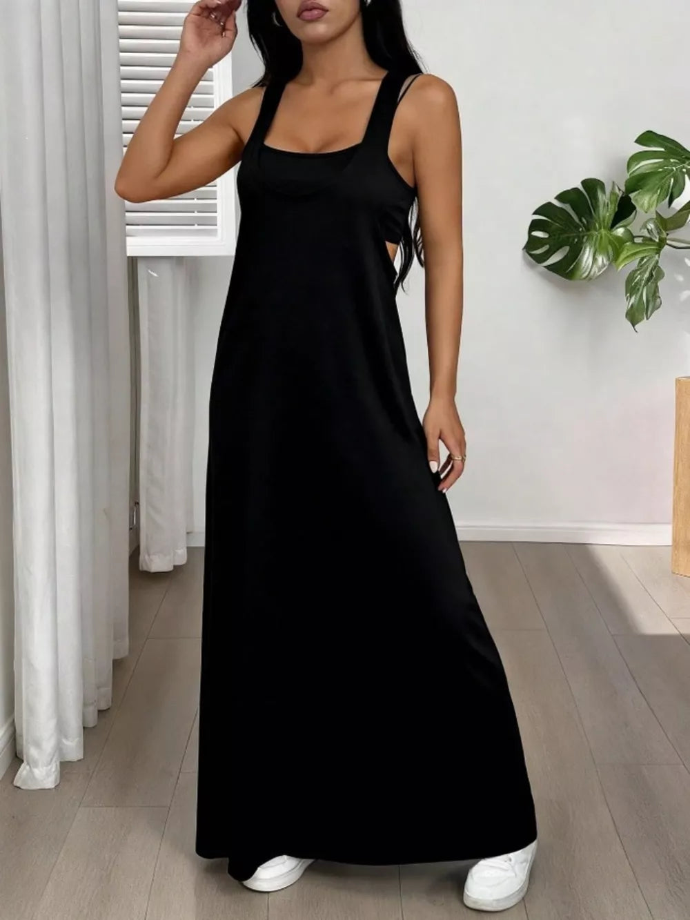 Black scoop neck cami maxi dress with side cutouts and double straps.