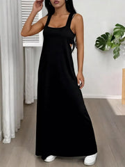 Black scoop neck cami maxi dress with side cutouts and double straps.