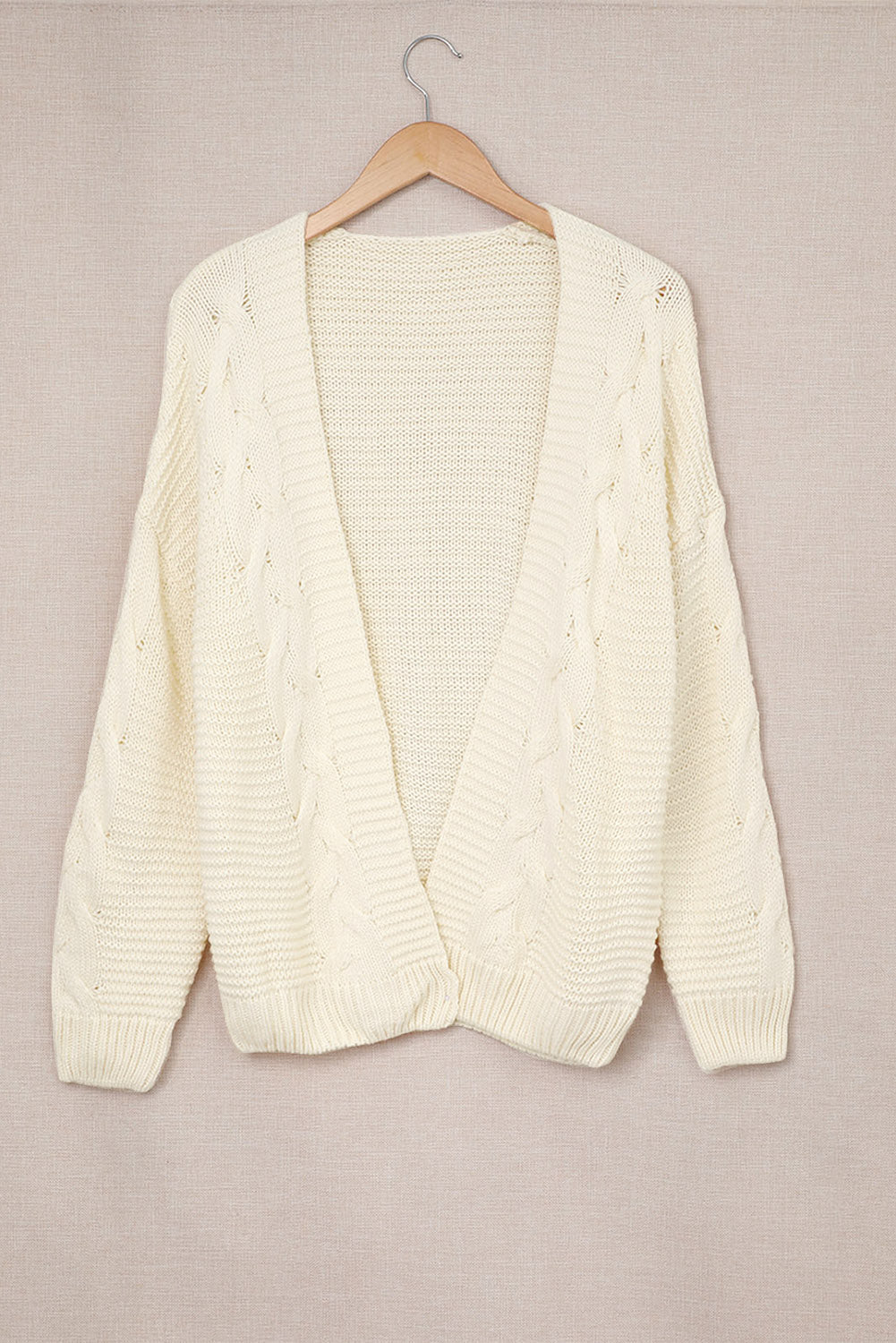 Ivory cable knit open-front cocoon cardigan with textured sleeves and hem.