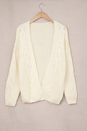 Ivory cable knit open-front cocoon cardigan with textured sleeves and hem.