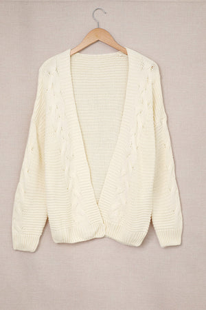 Ivory cable knit open-front cocoon cardigan with textured sleeves and hem.