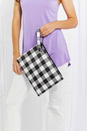 Gingham wristlet pouch with metal ring in black and white.