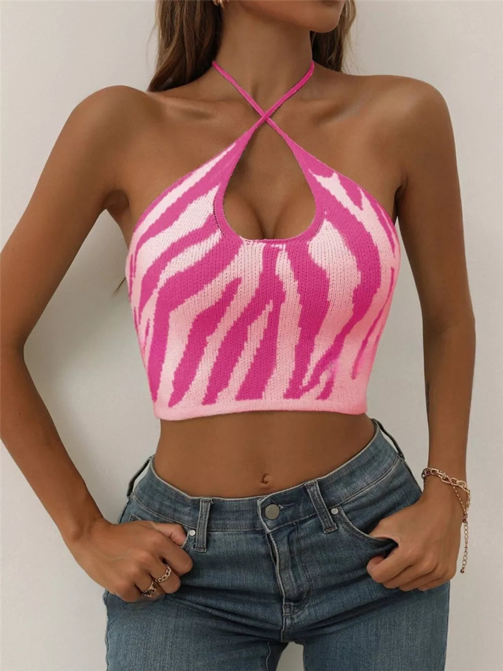 Hot pink zebra-striped halter knit cami with crisscross neckline.