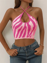 Hot pink zebra-striped halter knit cami with crisscross neckline.