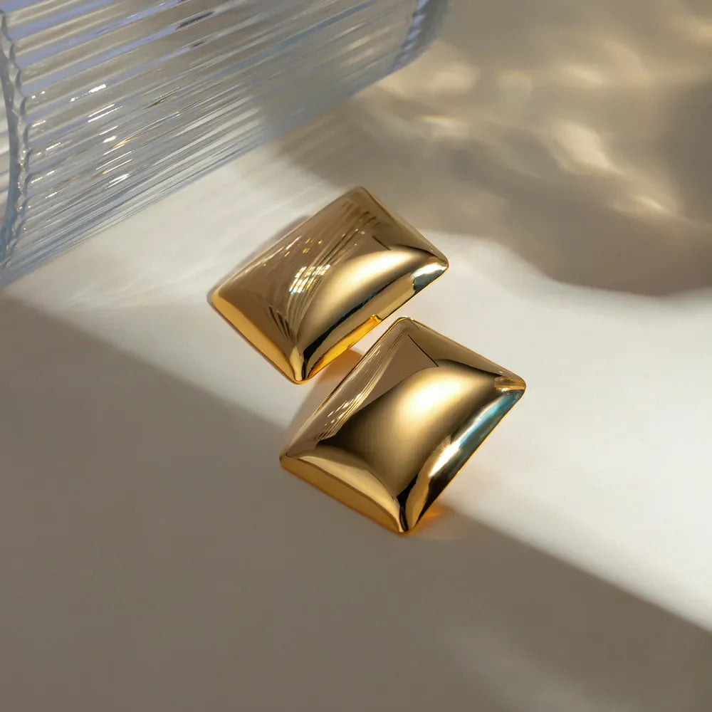 Sculpted gold rectangle earrings with a polished finish.
