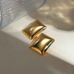 Sculpted gold rectangle earrings with a polished finish.