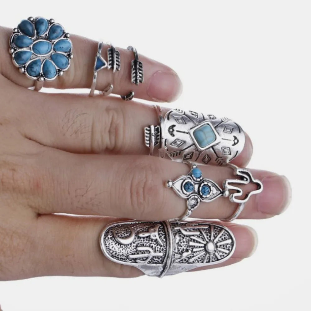 Bohemian silver ring set with turquoise stones and celestial, arrow, and eye designs.