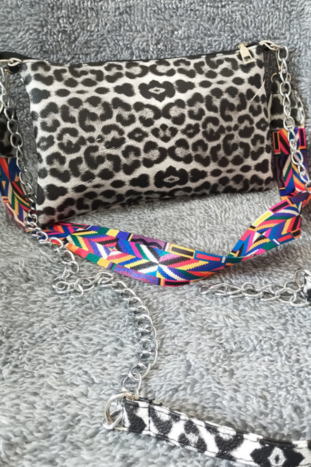 Leopard print shoulder bag with colorful geometric strap and chain detail