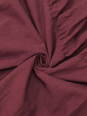 Red maternity maxi dress with ruffled detail and textured fabric