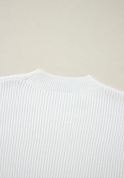 White ribbed knit sweater with mock neck and subtle heart embellishment detail.