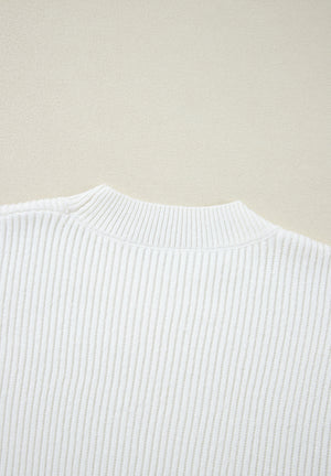 White ribbed knit sweater with mock neck and subtle heart embellishment detail.