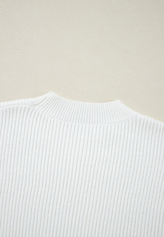 White ribbed knit sweater with mock neck and subtle heart embellishment detail.