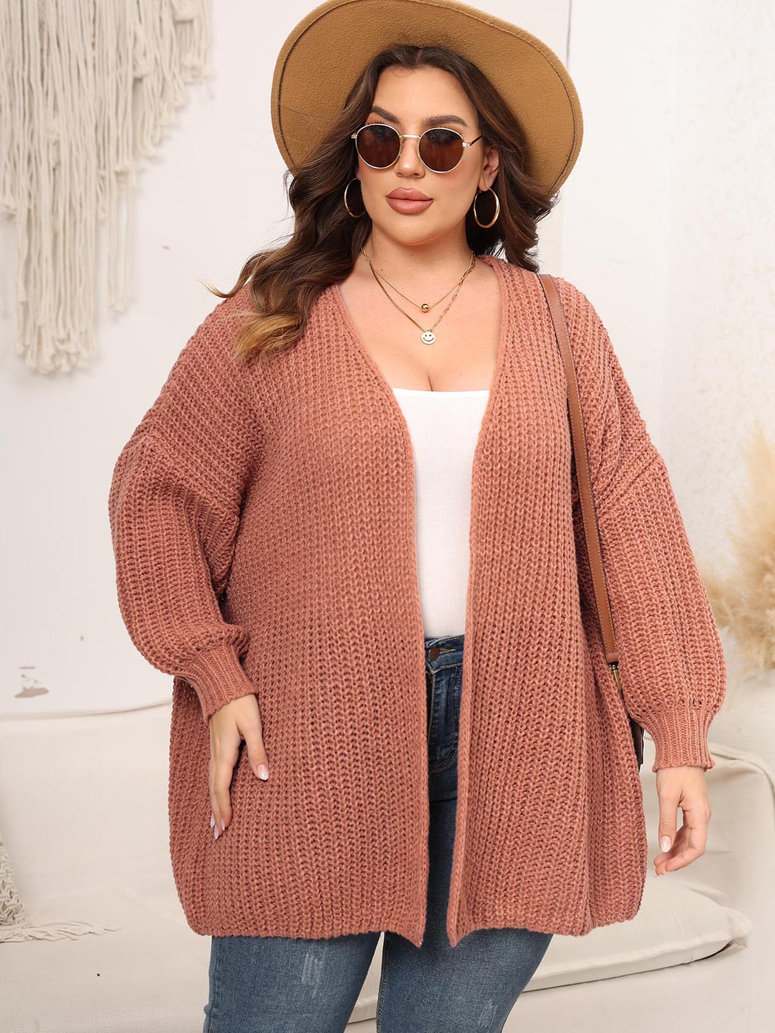 Chunky knit cardigan in coral with balloon sleeves and open front.