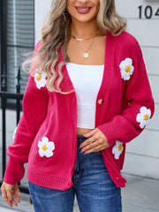 Watermelon pink acrylic V-neck cardigan with white daisy appliqués and buttons.