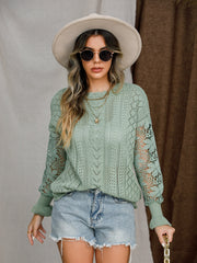Light green acrylic openwork sleeve knit sweater with cable knit details.