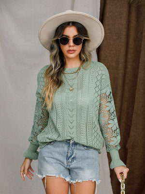 Light green acrylic openwork sleeve knit sweater with cable knit details.