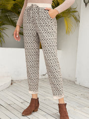 Geometric print drawstring trousers with cuffed hems and pockets.