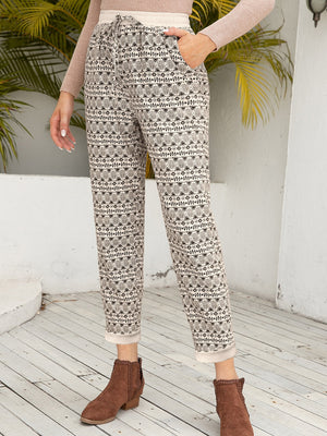 Geometric print drawstring trousers with cuffed hems and pockets.