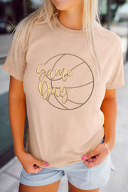 Beige cotton graphic t-shirt with gold "Game Day" text over a basketball outline.