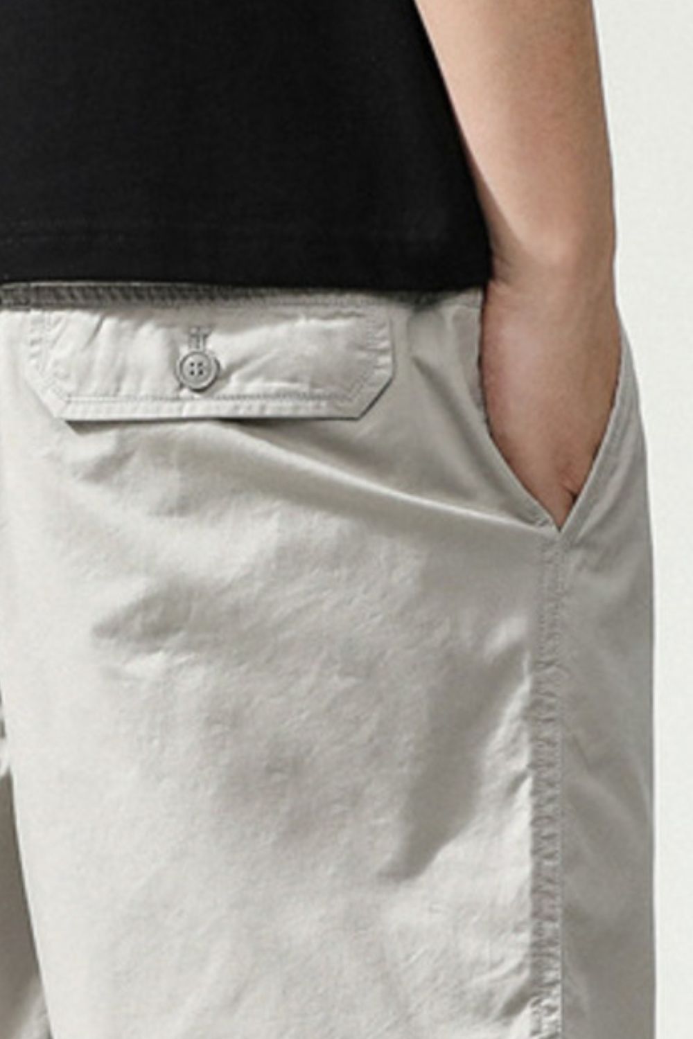 Light gray chino shorts with button-flap back pocket and side pocket detail.