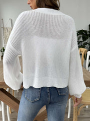 White balloon sleeve cardigan with buttoned front and textured knit.