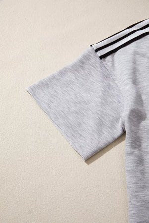 Grey relaxed t-shirt with black and white shoulder stripes and raw hem sleeves.