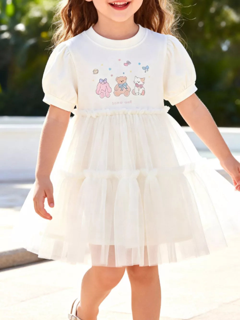 Cream cotton dress with puff sleeves and cartoon bear print, tiered tulle skirt.