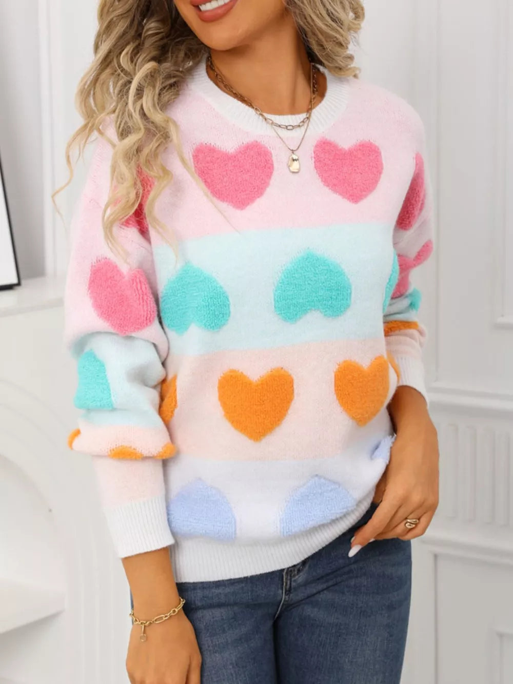 Fuzzy knit sweater with colorful heart pattern and crew neck.